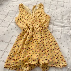 Size medium yellow romper with pink and blue flowers